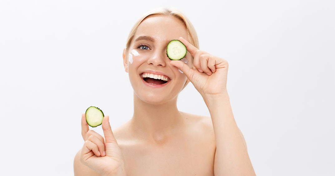 beautiful woman put cococumber to her eyes