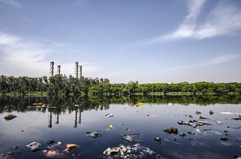 photo of pollution, polluted water source near an industrial factory