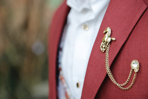 Brooch secured on a coral suit blazer