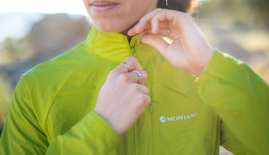 Model wearing Montane Featherlite windproof jacket in citrus spring