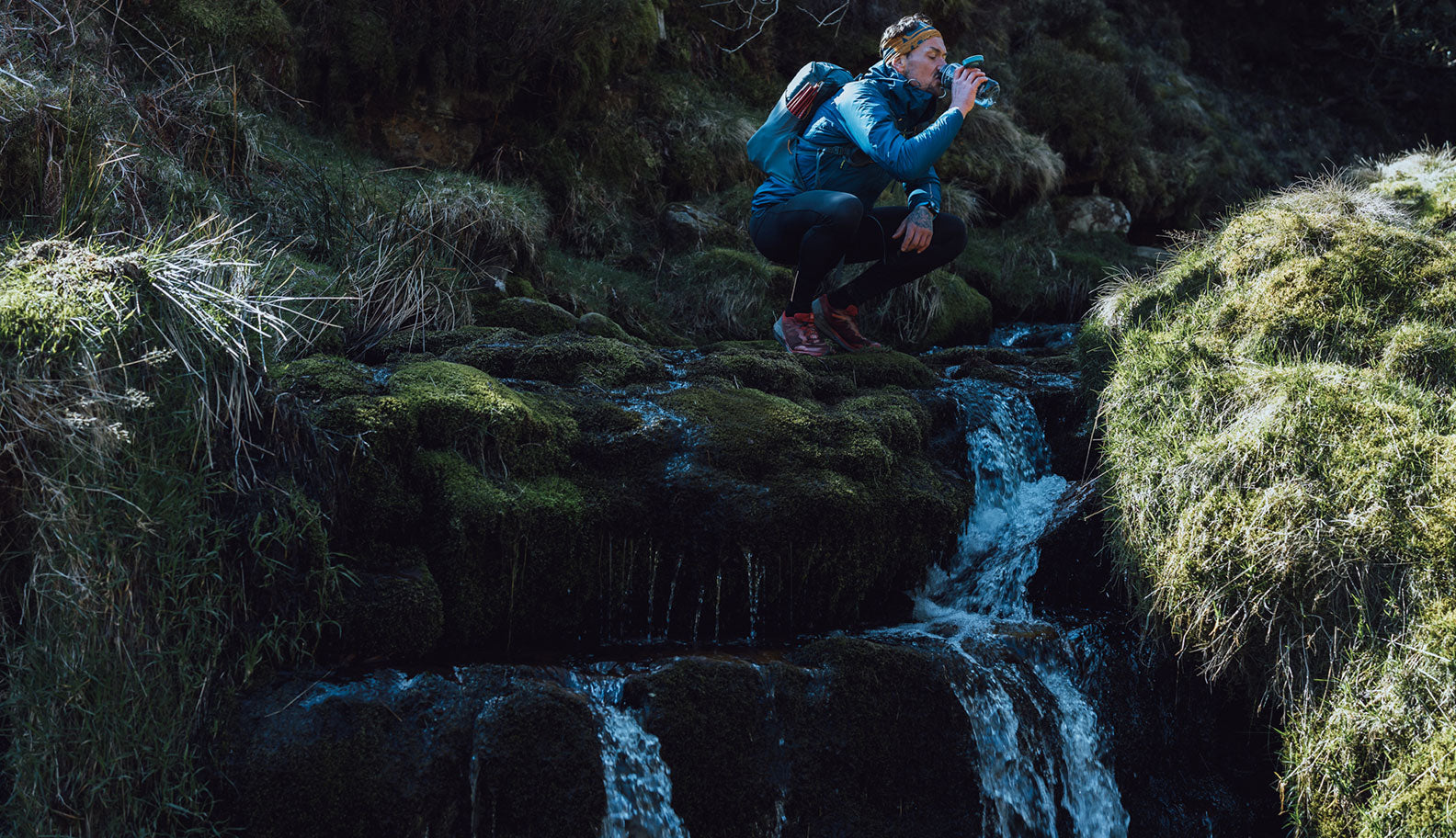 Howard takes a rest by a waterfall in the Peak District | Montane 