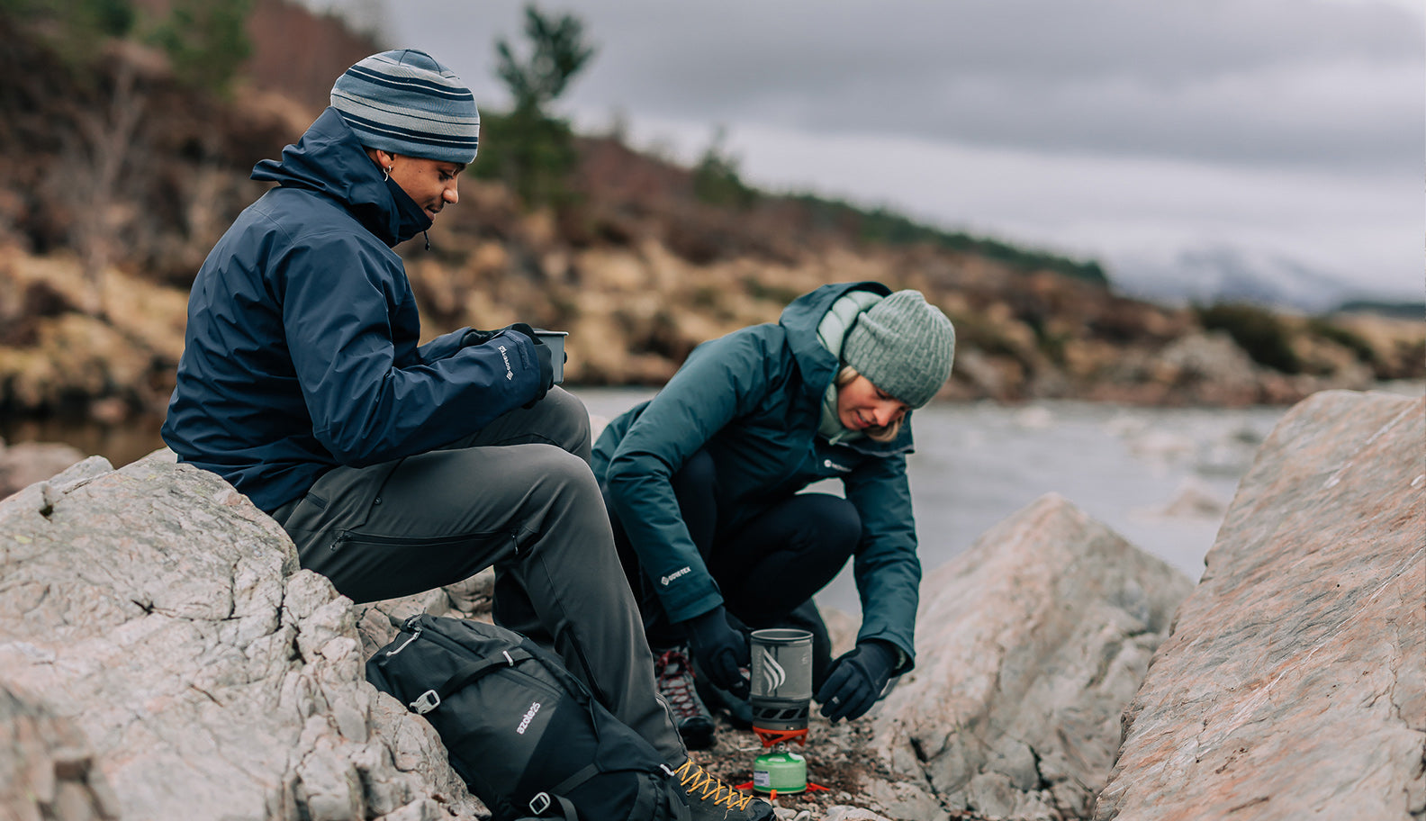 two-people-drinking-hot-drink-from-portable-stove