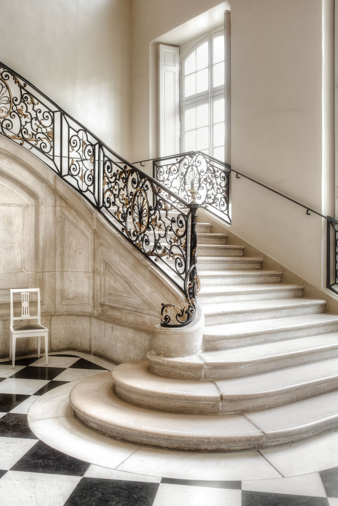 fine art print escalier, beautiful staircase in Paris with wrought-iron balustrades, curved steps, black and white checkered floor.