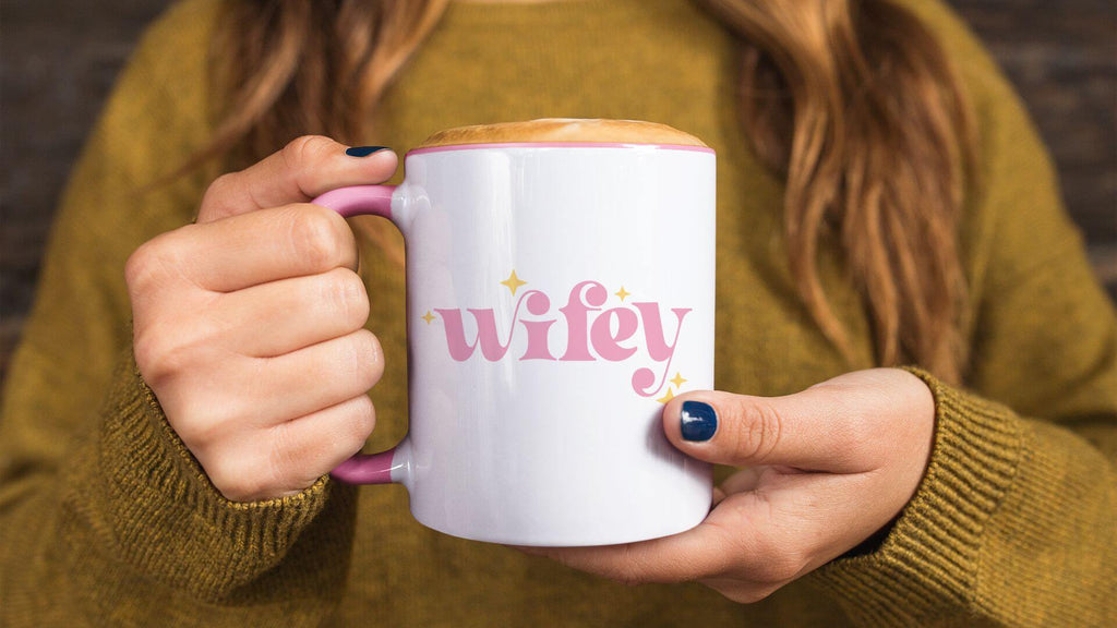 Woman in cozy sweater holding Coley Made Wifey mug
