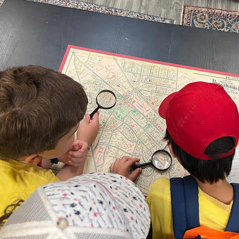 3rd grade children studying a map of Wayne
