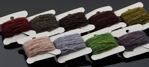 Image of 9 Colors of Jamieson's Shetland Spindrift Yarn spooled up in 5 yard increments.