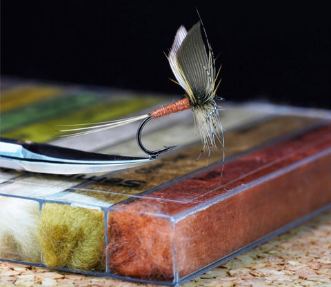 Image of the Kapok Dubbing from the Semperfli Fly Tying Materials Company in a Combo Pack with a fly tied using the material on top of the case.