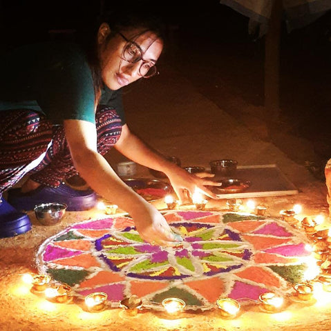 Nepali girl making rangoli on Deepawali