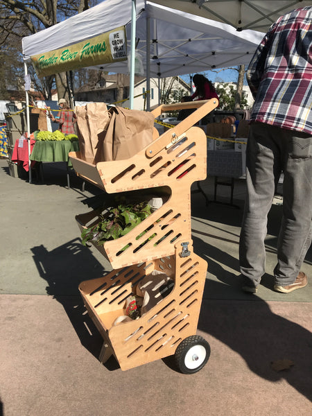 Wood shopping cart holding produce at Davis Farmers Market