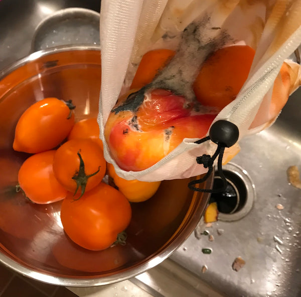 smushed yellow heirloom tomatoes in a bowl