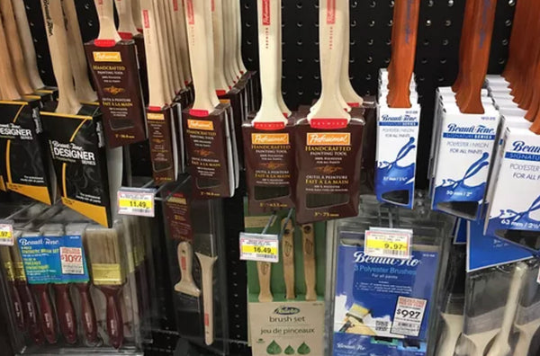 various paint brushes hanging on wall