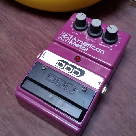 Purple rectangular effects pedal. 3 gray knob at the top. Black plastic footswitch at the bottom. "DOD" written in bold font on a silver background.