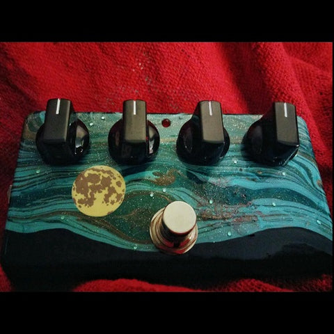 Woolly Mammoth fuzz pedal with a moon and blue and black night sky painted on it.