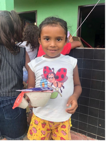 young girl with acai bowl