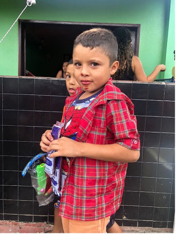 young boy with acai pack