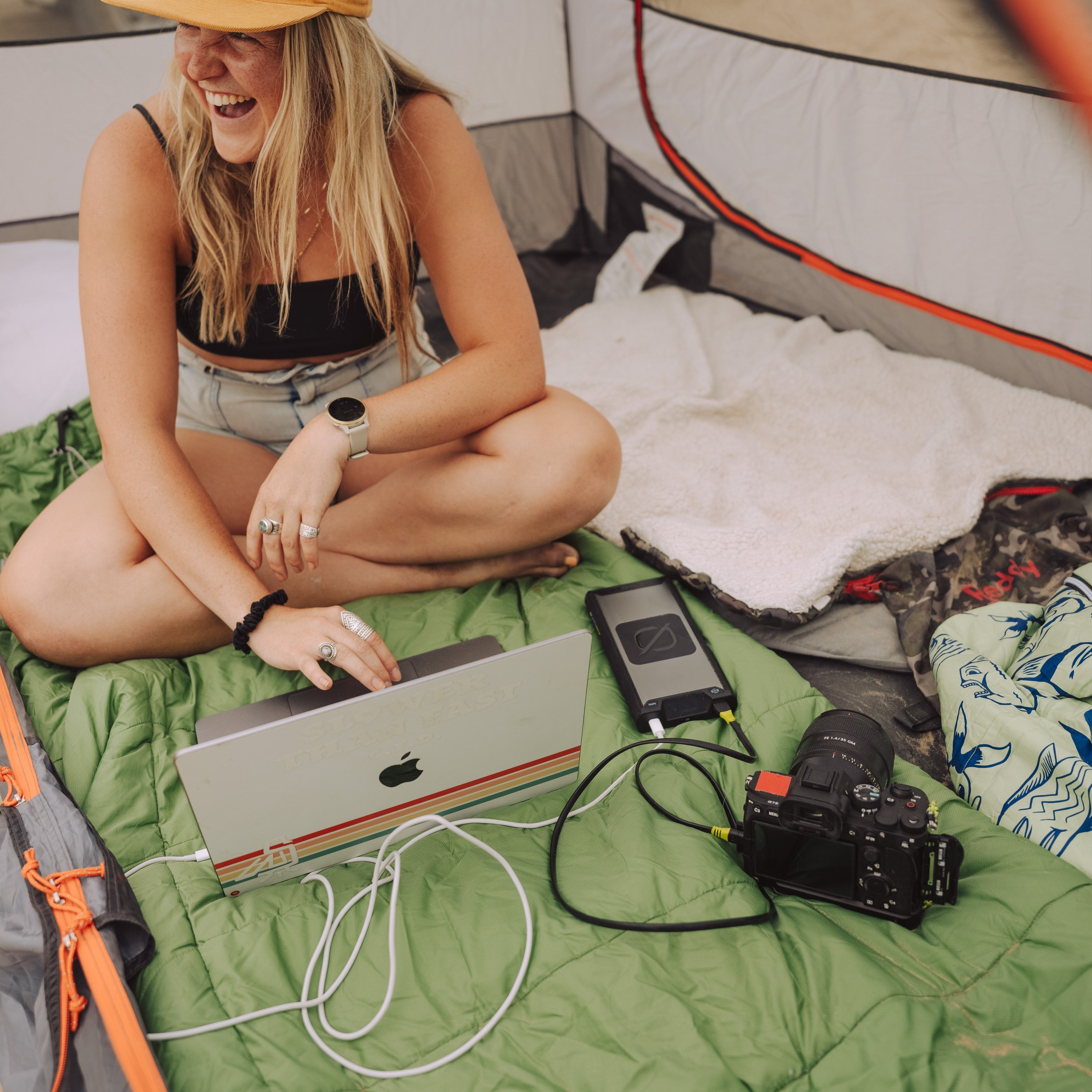 New Sherpa 100PD Wireless Charging Power Bank charging an Apple MacBook and Camera at the same time