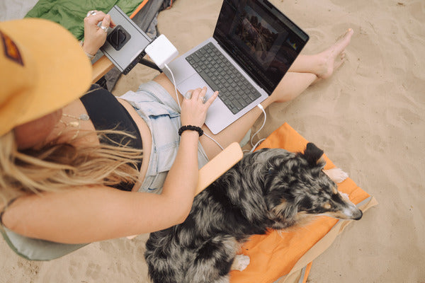 A laptop powered by a Sherpa power bank