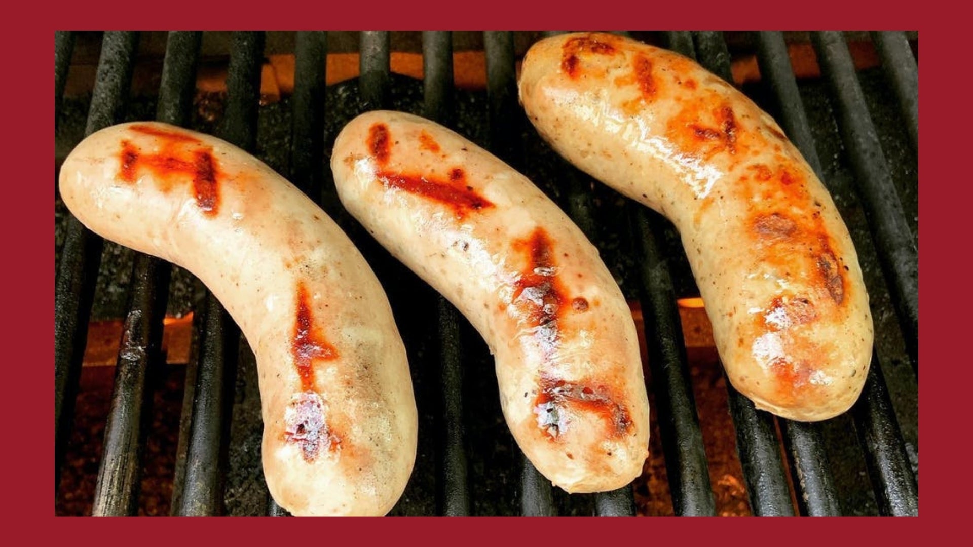 Bratwursts being cooked on a grill with grill marks on them.
