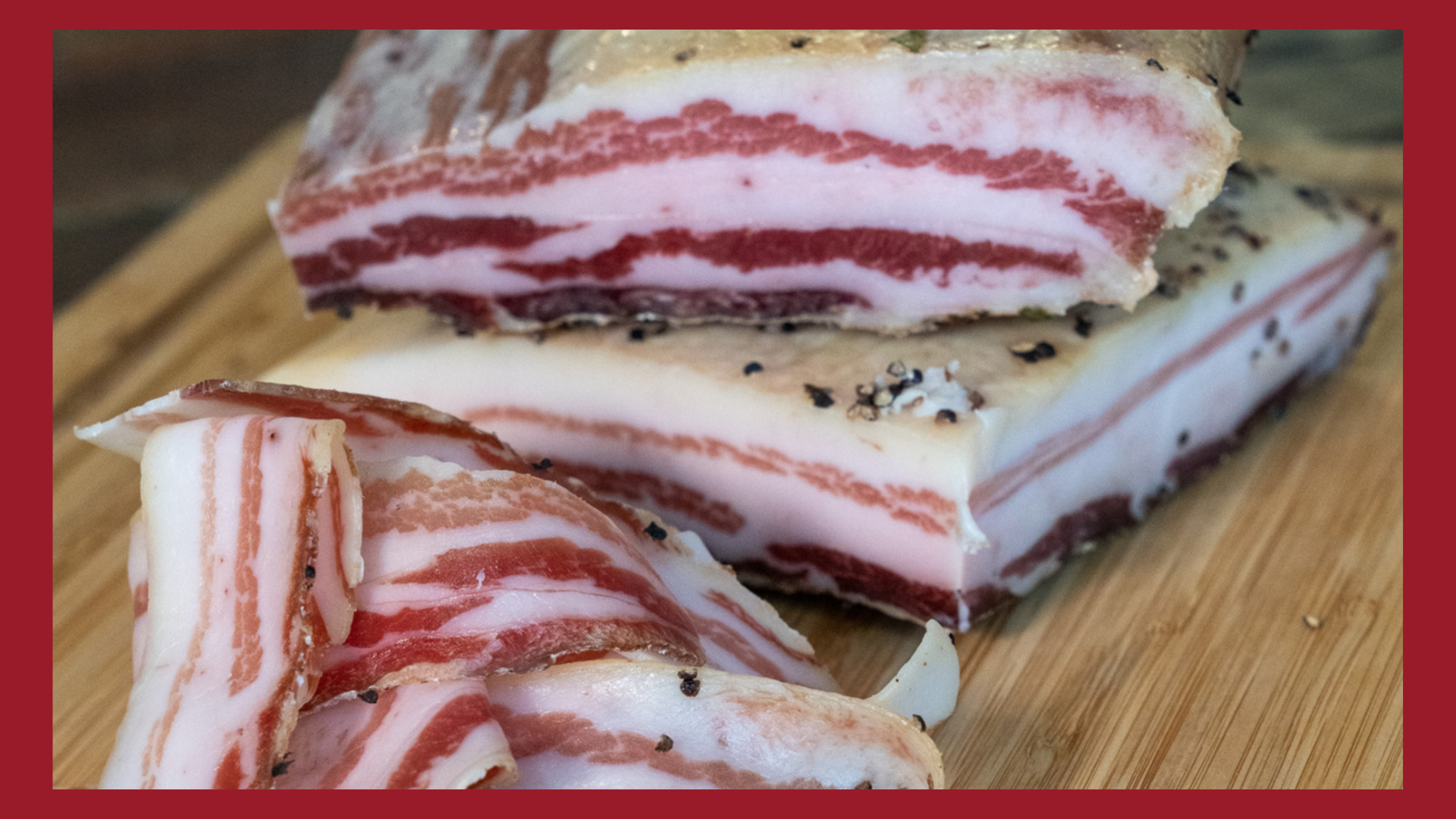 A close up picture of pancetta in whole chubs and in slices on a cutting board.