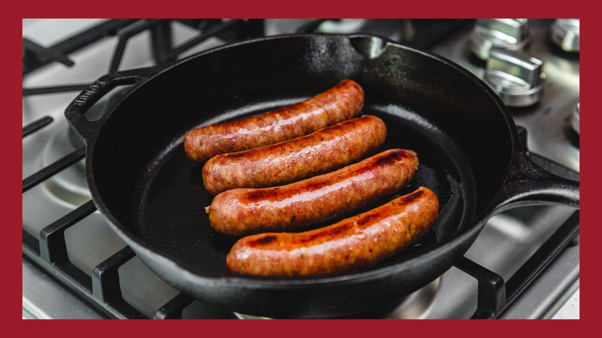 Bratwursts cooking in a cast iron skillet.