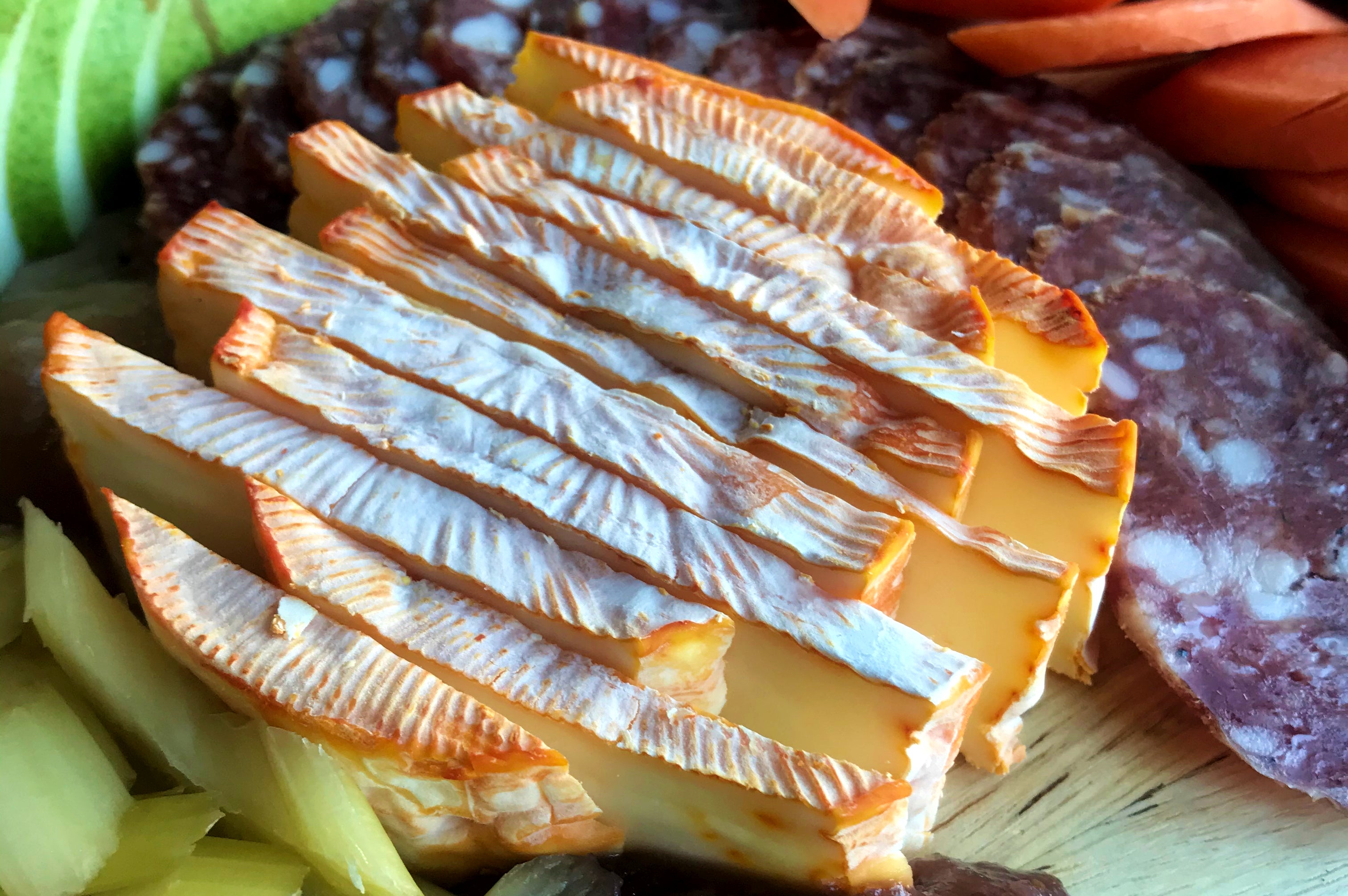 A close up image of ColoRouge soft cheese from MouCo in Colorado on a charcuterie board.