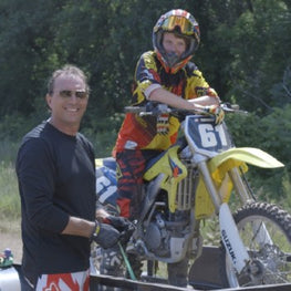 OmegaStrap founder Brad Willodson strapping a motorcycle to a trailer.