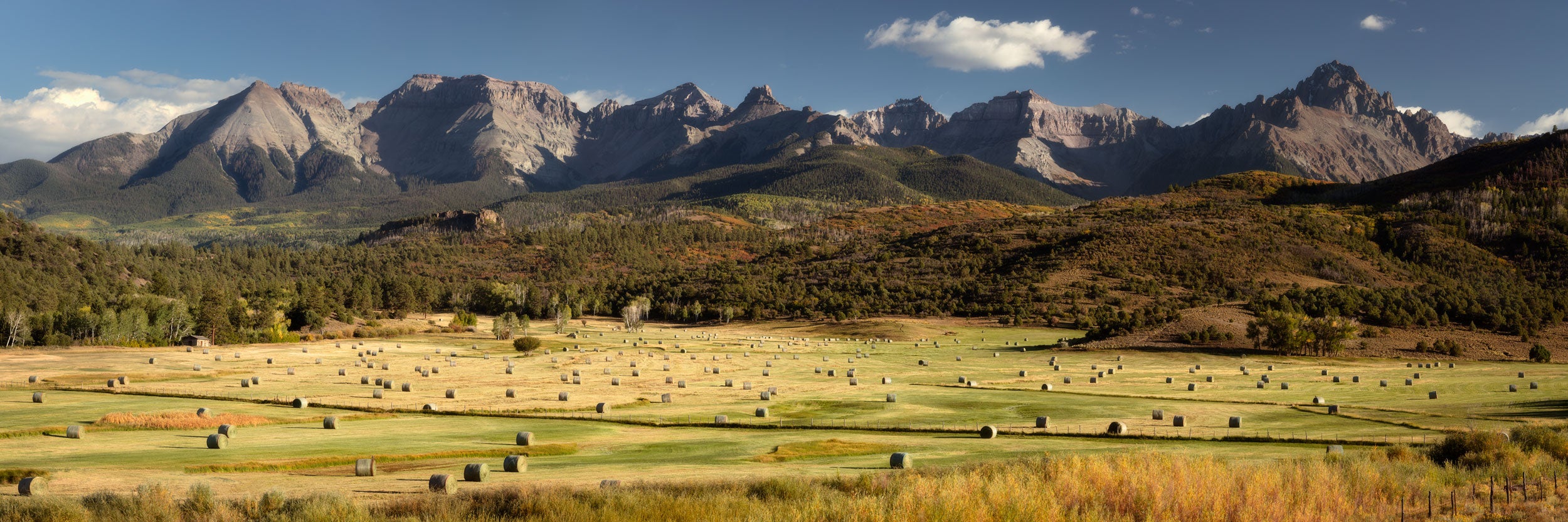 A Lars Gesing fine art nature image of the Ralph Lauren Double R ranch near Ridgway in Colorado's San Juan Mountains, with Mount Sneffels in the back, during fall color season. The best time to see the fall colors in Colorado is usually late September and early October.