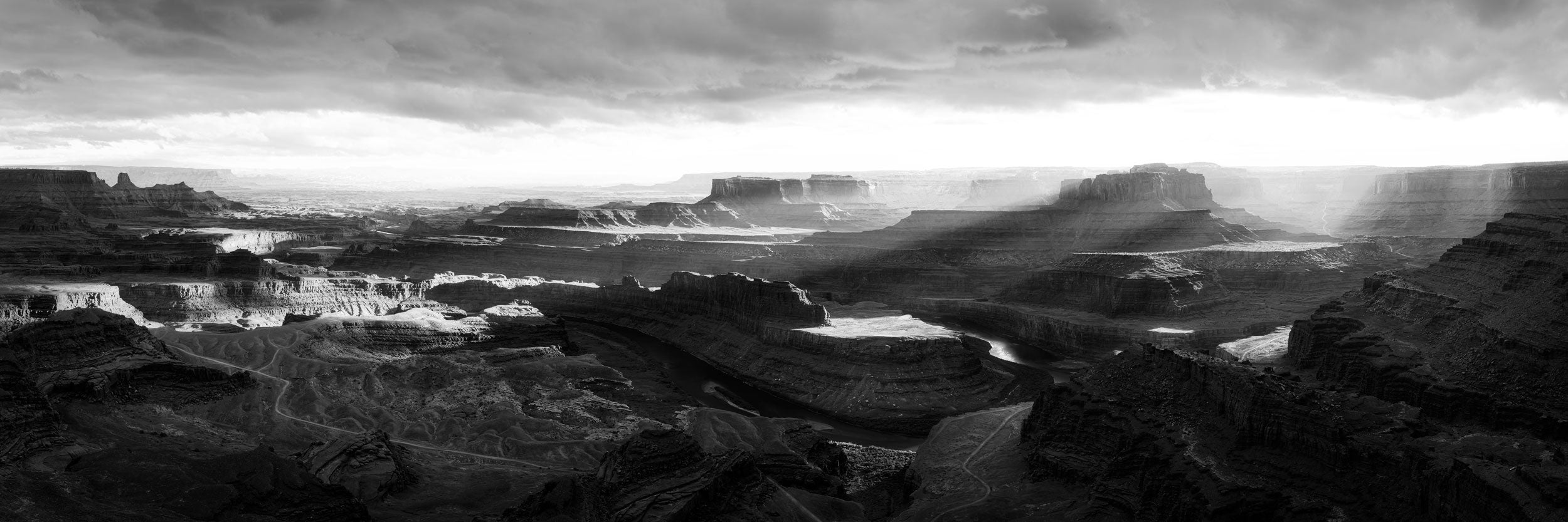 A Lars Gesing fine art black and white nature photograph of Dead Horse Point State Park at sunset, a must-see and fun thing to do near the adventure town of Moab, Utah, close to Canyonlands National Park and Arches National Park.