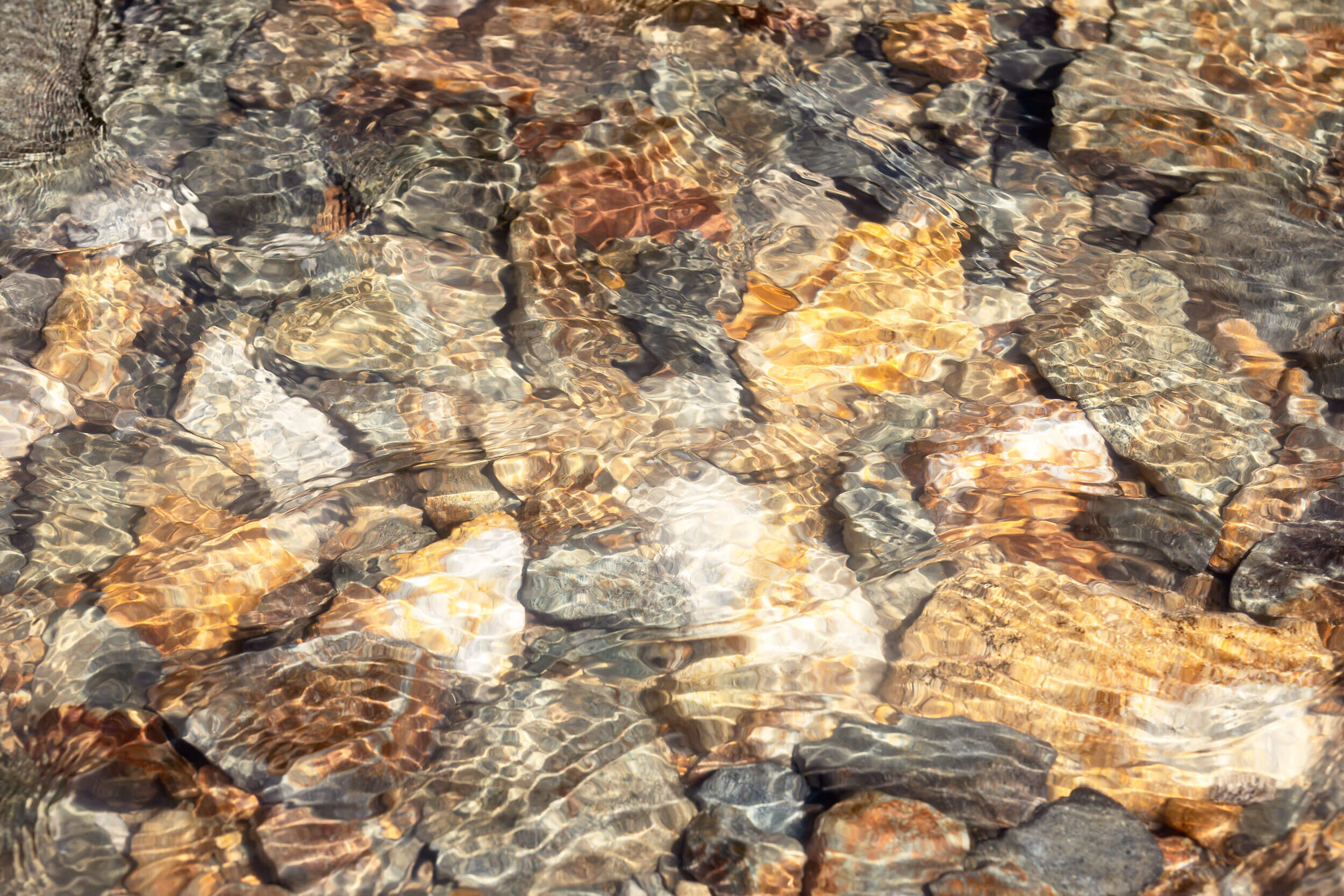 This piece of Telluride art shows river rocks in Colorado.