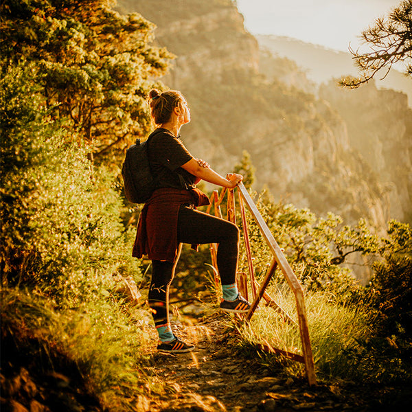 woman hiking on a path at dusk