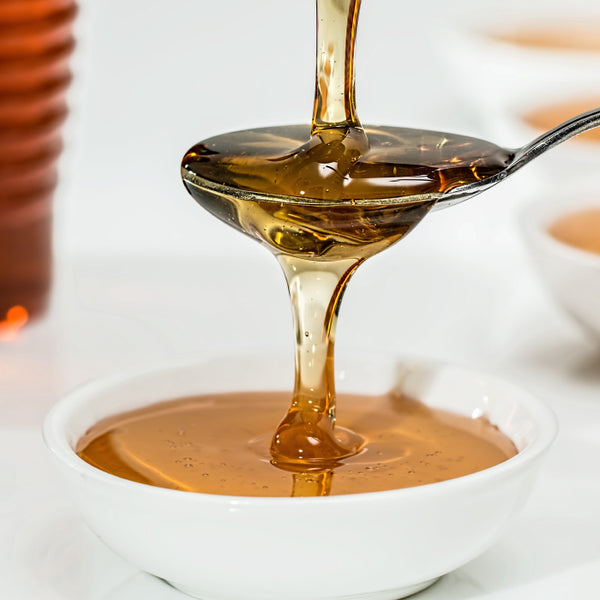 honey drizzled over a spoon