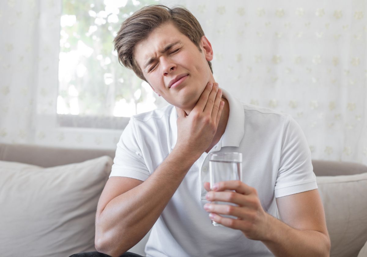 man suffering from sore throat