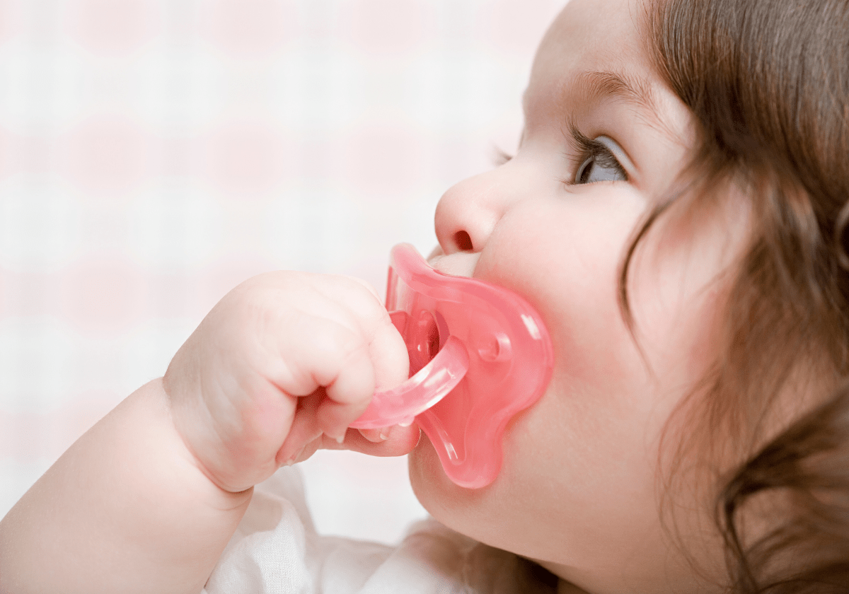a baby with a pacifier in the mouth