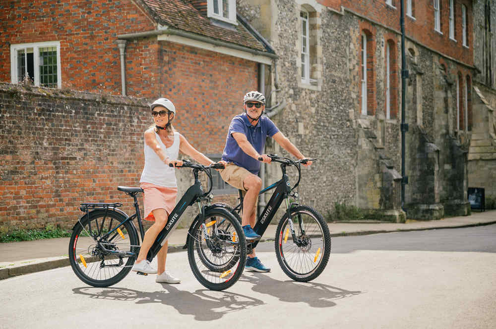 A couple riding electric bikes to work