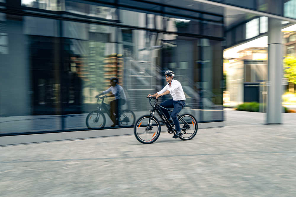 A man commutes to get off work on a Netuno electric bike