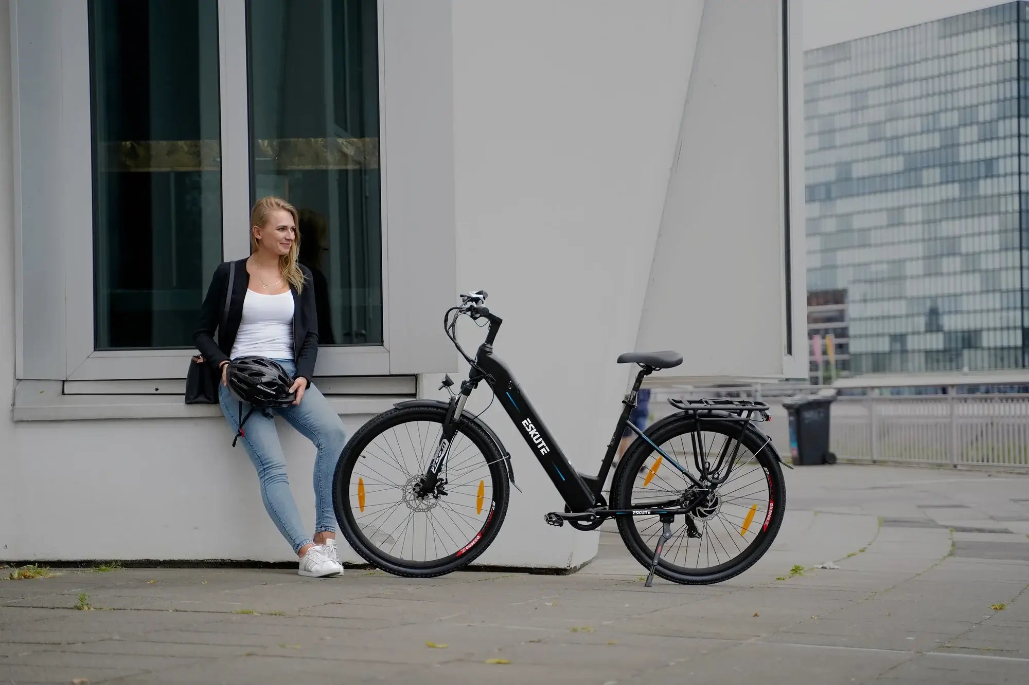 A woman parked her electric car next to the building