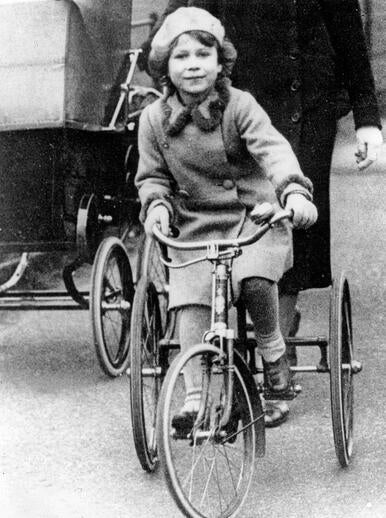 young Elizabeth riding a tricycle in Windsor Park