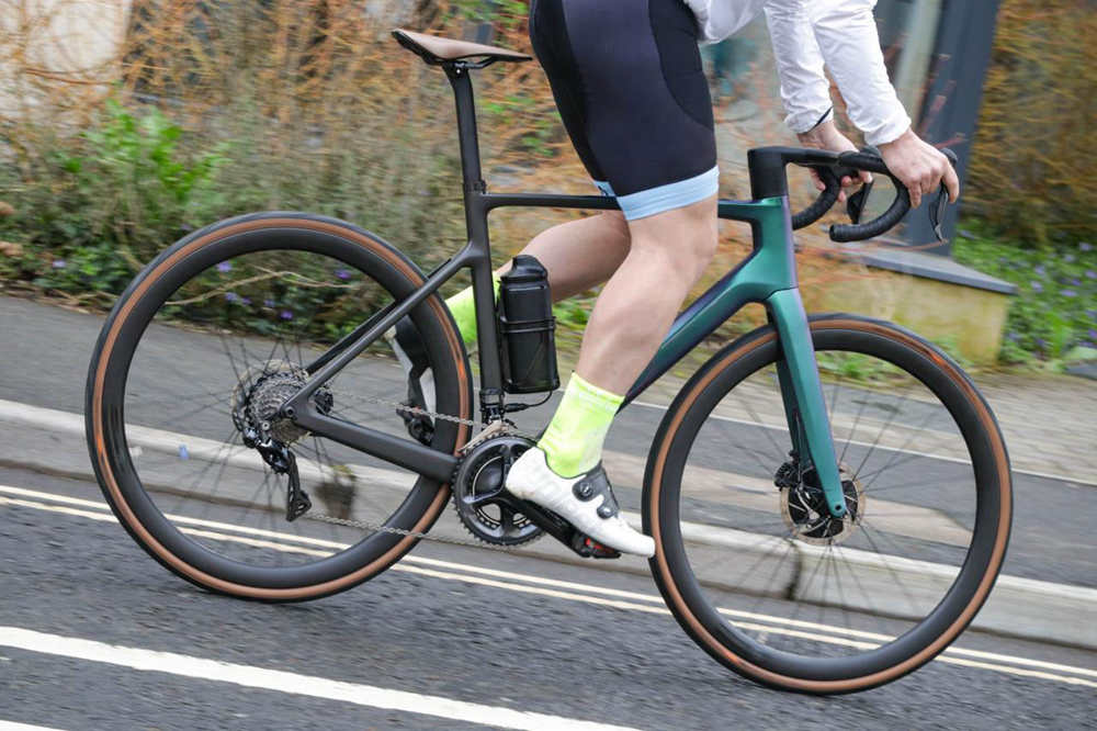 a man is pedalling his electric road bike
