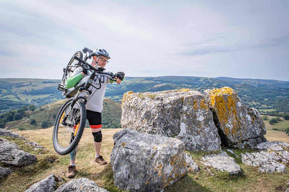a man rides to the mountain top for getting some exercise