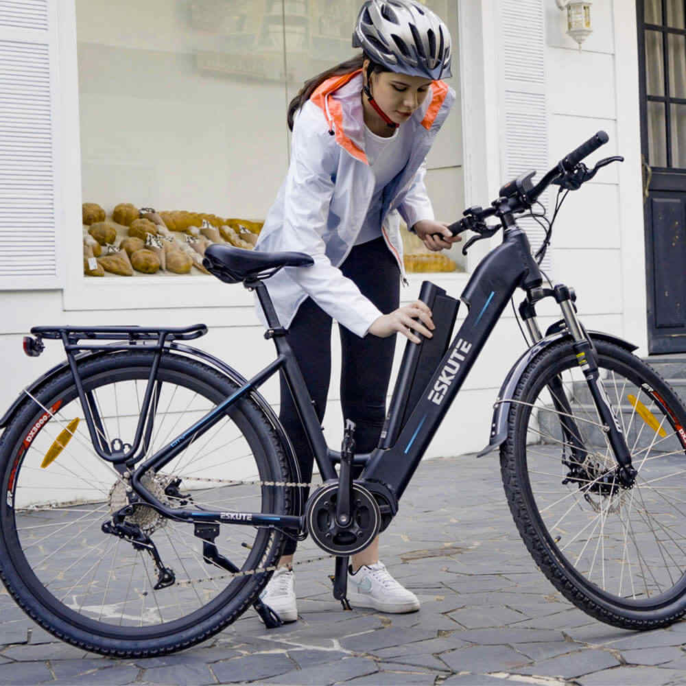 a lady is replacing electric bike battery