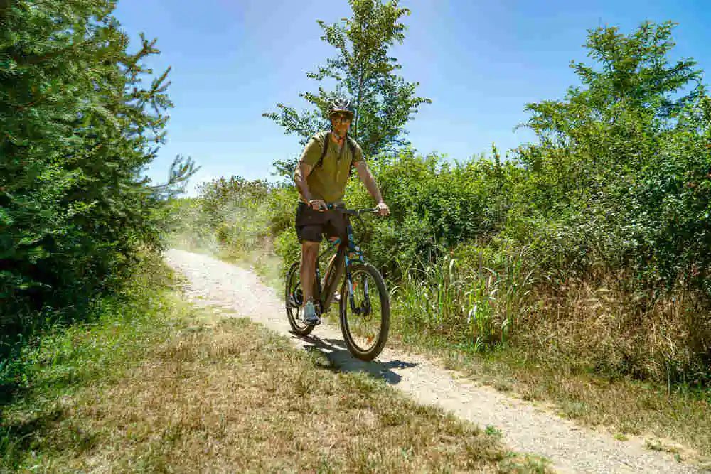 a young man with a helmet rides his e-bike