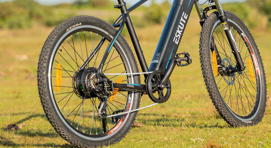 electric mountain bike with derailleur gears on the grasslands