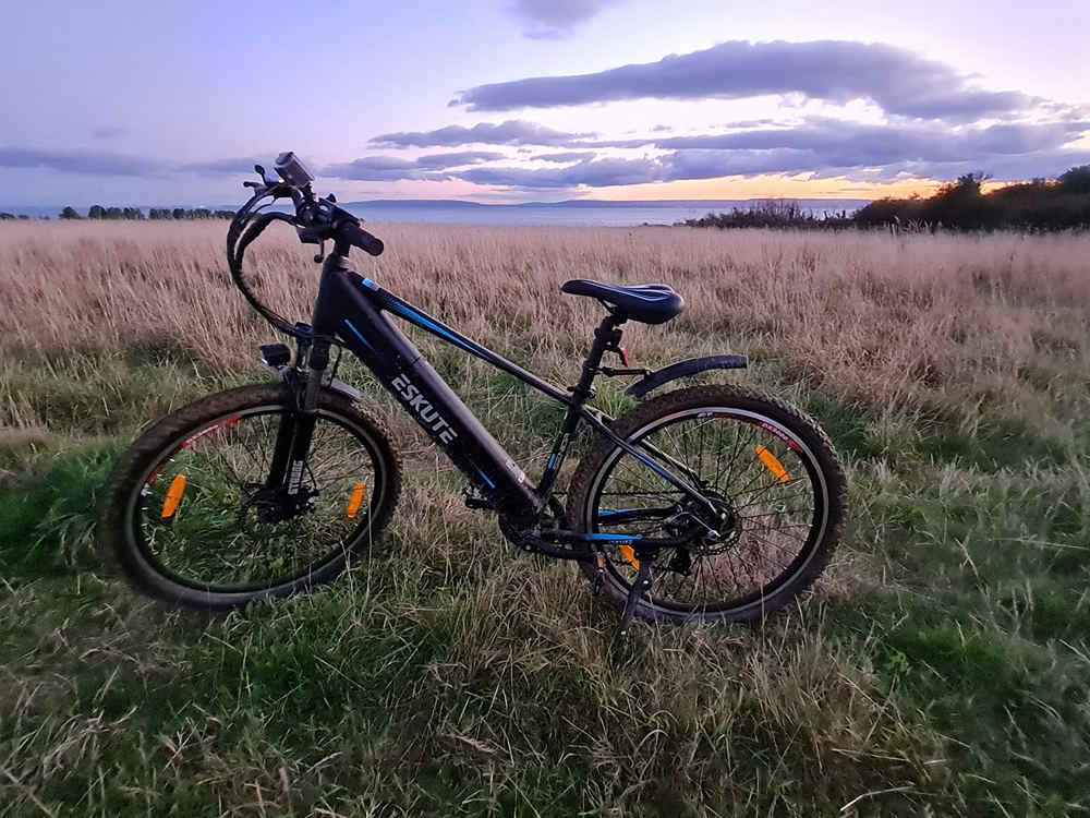 electric bike on the grassland in the sunset