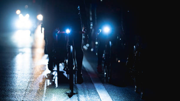 people ride electric bikes in group at night