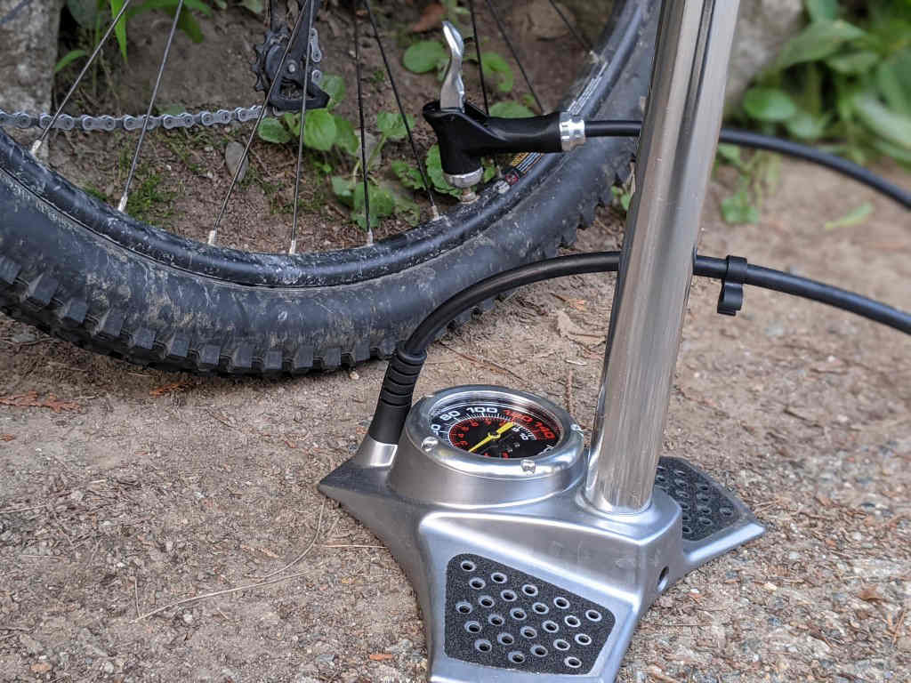 use the floor pump with a gauge to inflate bike tire