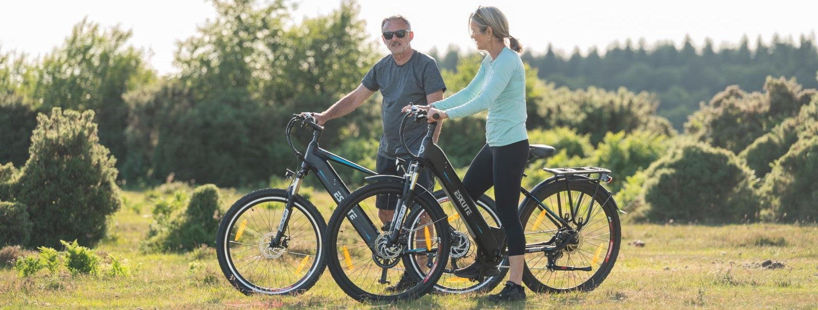 a couple is riding hub motor ebikes in the wild