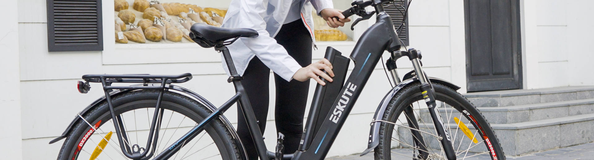 A woman is replacing an electric bike battery 