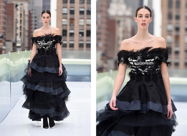 Elaine - Off the shoulder neckline with feathered shoulders, black plastic belt with feathers. Voluminous 3-layered skirt, each layer with tulle and silk. Mimiela at NYFW