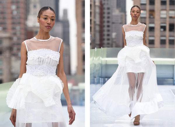 Elena - White dress with hand-applied embroideries on the top and inner skirt, pleated fabrics complementing the waist and hips, accented by a long tulle bottom with a thick white satin accent. Mimiela at NYFW