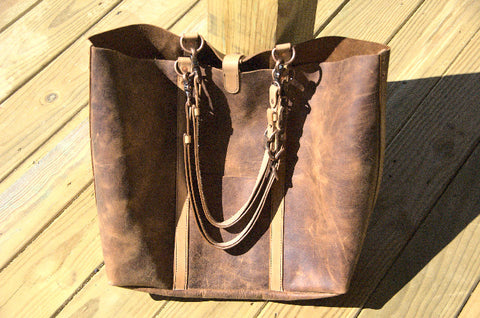Wanderer shoulder bag  in the sun. Bright chestnut pull-up leather with natural veg-tanned and oiled straps. 